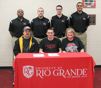West Jefferson High's Kyle Rollins poses with his parents and Rio Grande coaches after signing with the RedStorm